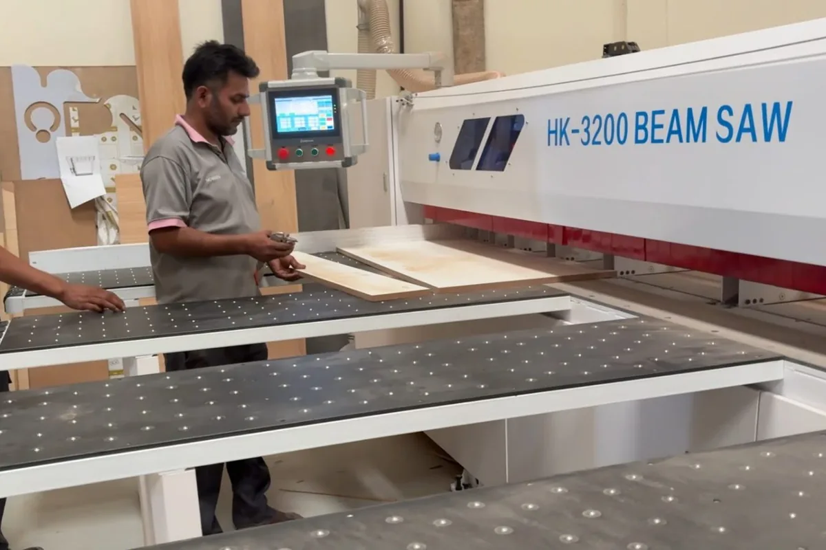 Operators cutting board on the HK-3200 CNC beam saw at the Olympic Furniture factory in Dubai Industrial City