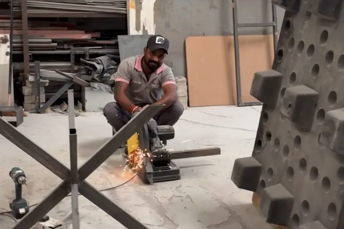Fabricator cutting steel tube for furniture frames at the Olympic Furniture factory in Dubai Industrial City