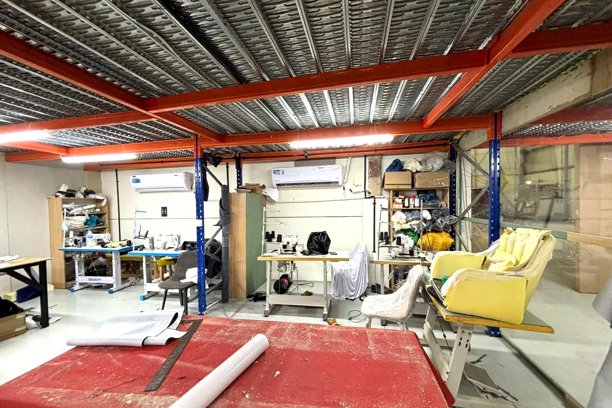 Industrial sewing machines, fabric cutting table and foam seat units in the Olympic Furniture upholstery unit in Dubai